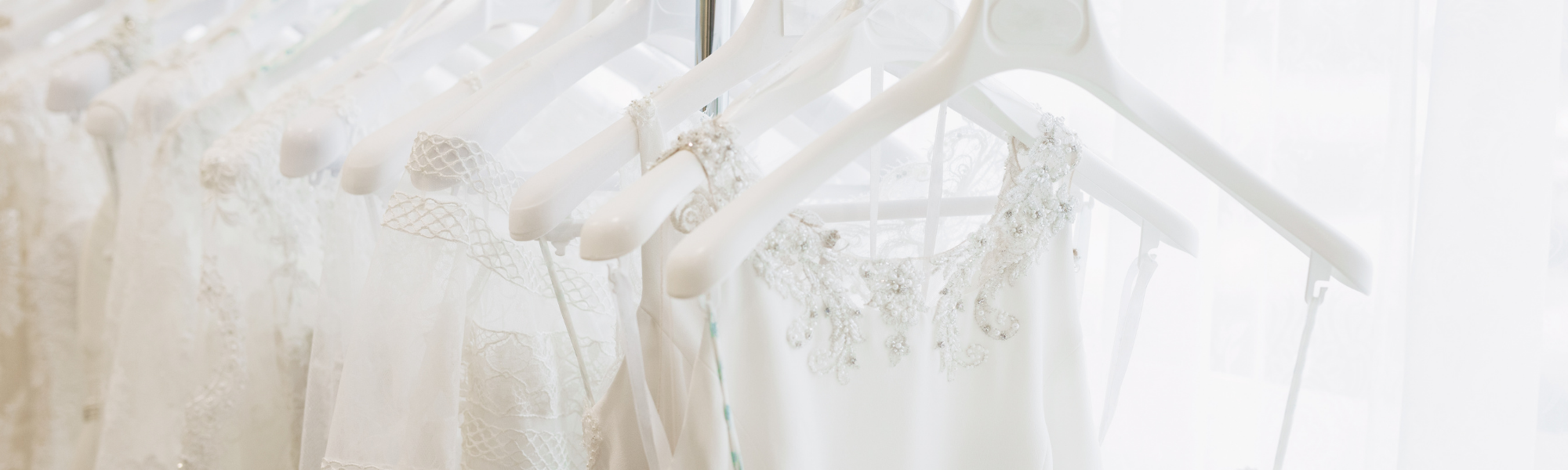 wedding gowns on a rack 